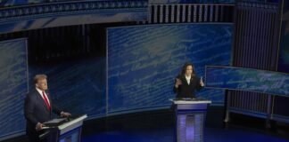 A sinistra Donald Trump a destra Kamala Harris sul palco blu nel corso dell'ultimo confronto televisivo verso le elezioni americane